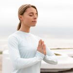 medium-shot-woman-meditating-outside_23-2149245763