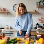 front-view-smiley-woman-cutting-ingredients_23-2149894580