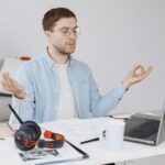 man-sitting-living-room-home-guy-enjoying-studying-using-laptop-headset-meditation_1157-48728