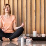 full-shot-woman-meditating-with-candles_23-2148897863