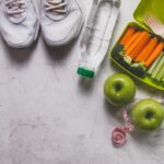 lunch-box-with-vegetables-sneakers-water-bottle-apples_23-2147601777