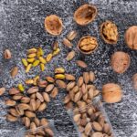 top-view-pistachios-walnut-glass-gray-texture-horizontal_176474-1314