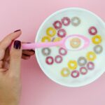 woman-holding-spoon-with-fruit-loop-cereal_23-2148266495