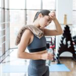 woman-with-towel-water-wiping-face_23-2147778525